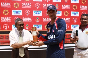 Nepalese captain receiving the Man of the Match award from Mr. Loajehi Ahmed Manik
